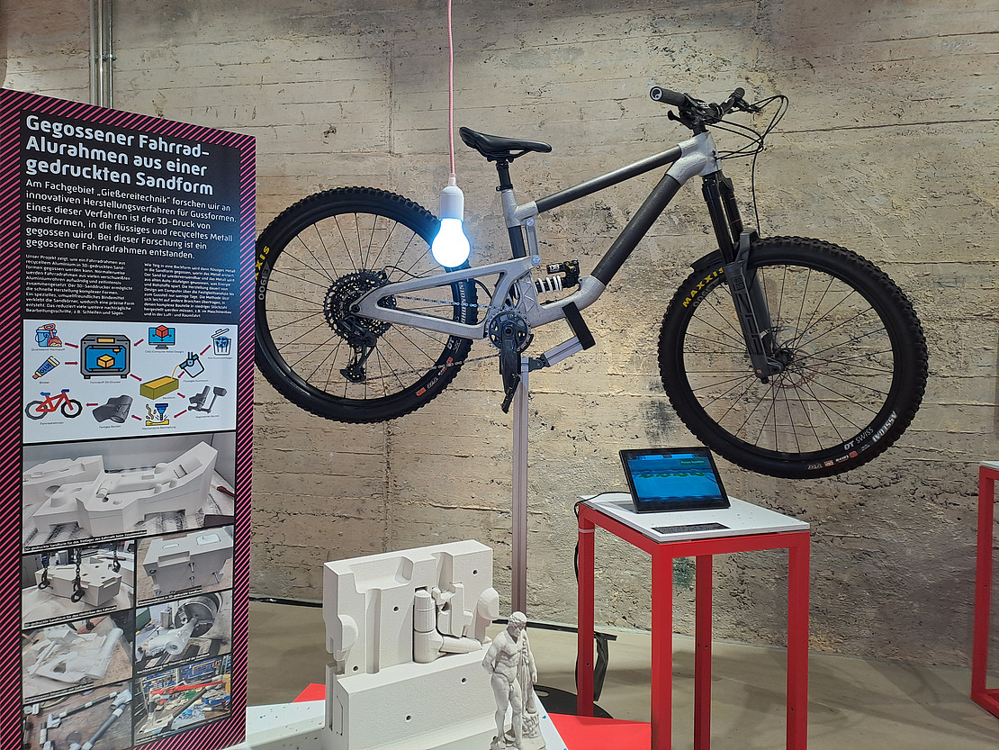 Station with bicycle, information text and illustrative material in the exhibition