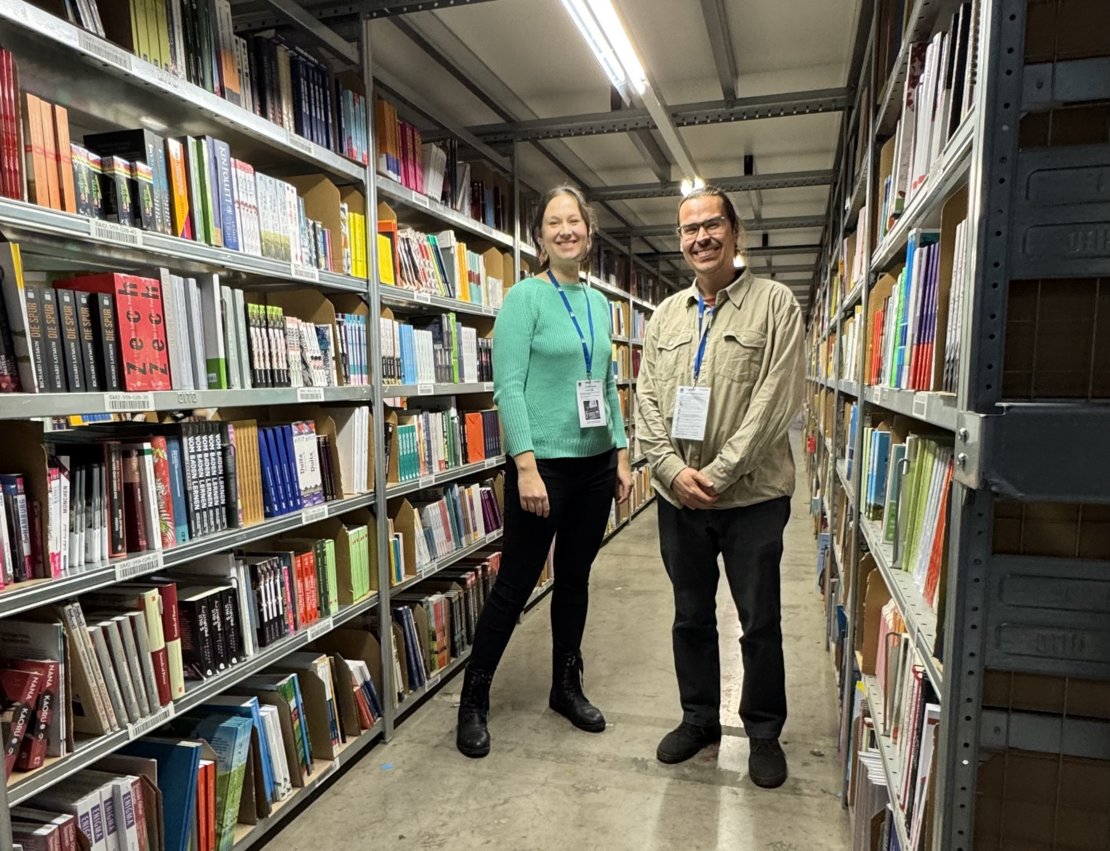 Dr. Anna Schomberg and an employee between shelves.