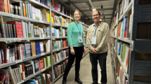 Dr. Anna Schomberg and an employee between shelves.