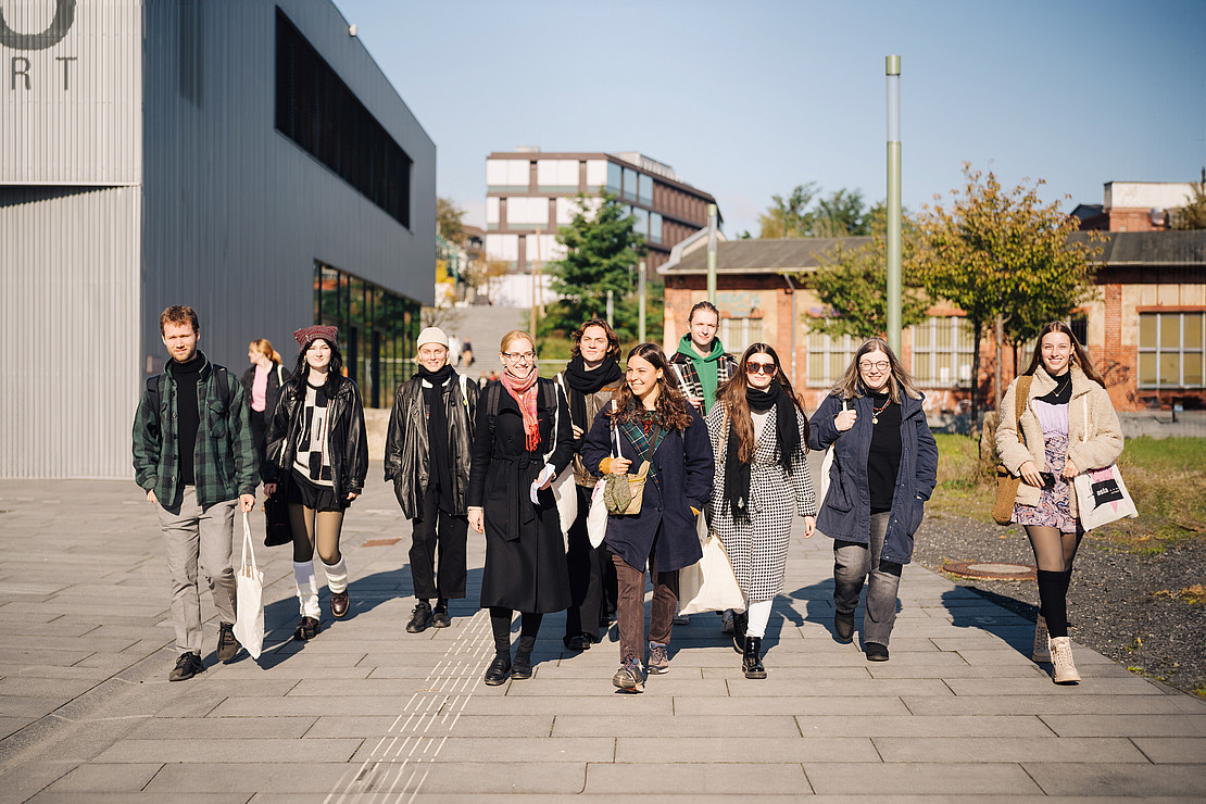 Group of students walking across the campus