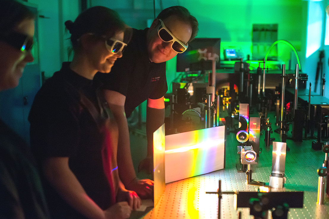 three people in the lab. 