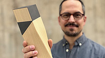 Darius Zalzadeh holds up a prize. 