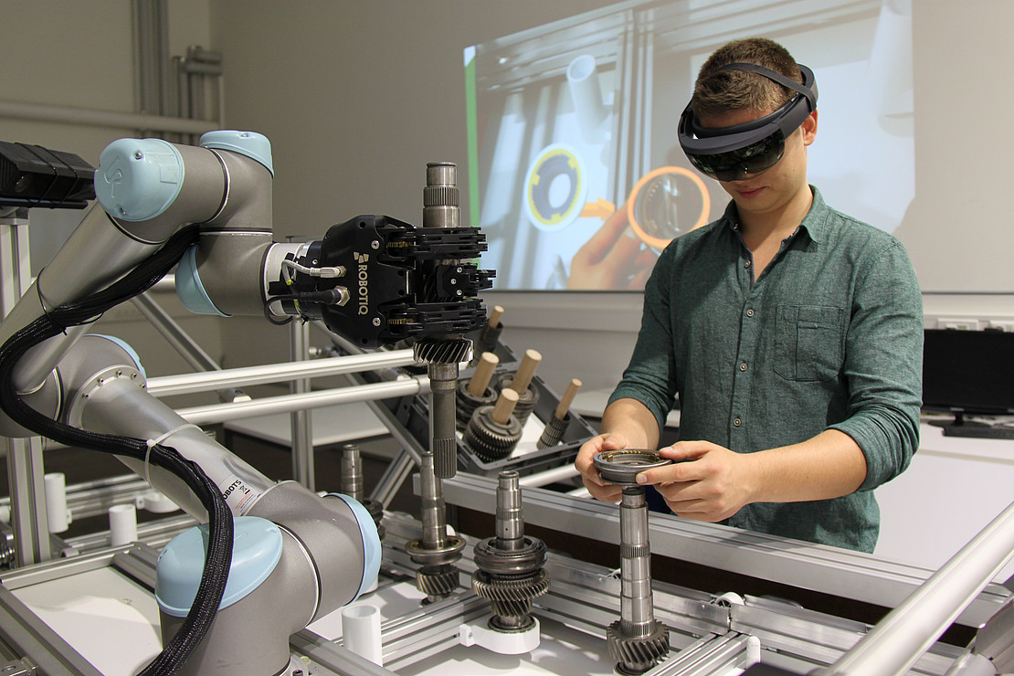 A man with AR glasses at a workbench.