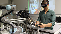 A man with AR glasses at a workbench.