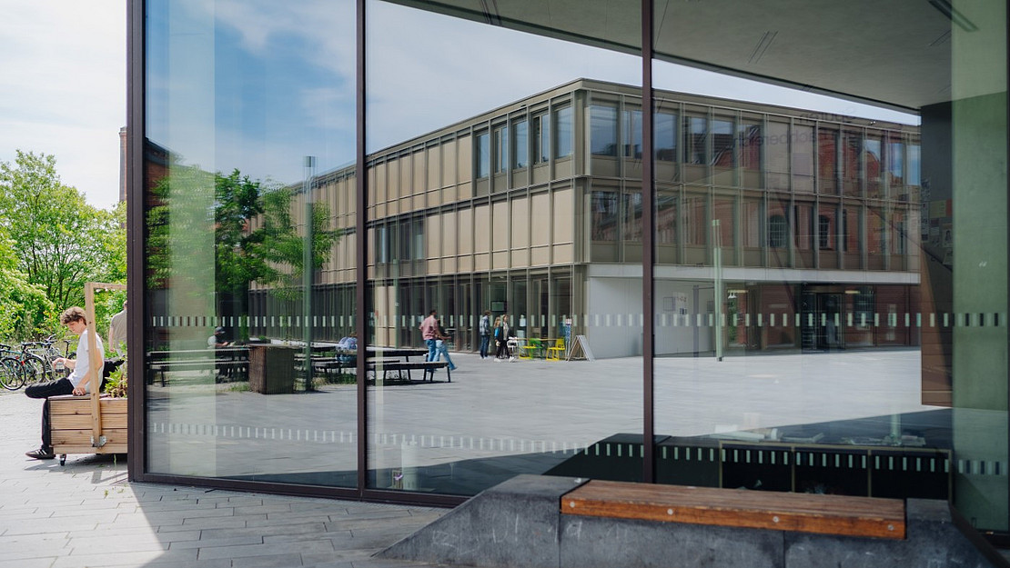 The Science Park is reflected in a glass front.